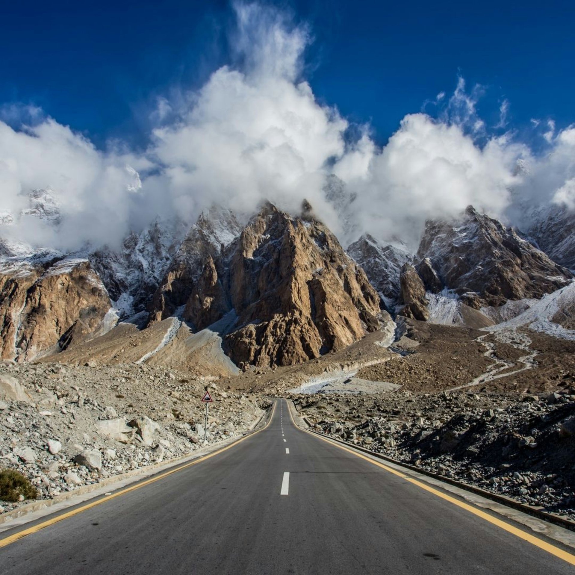 Snow-capped peaks over a green valley in Gilgit-Baltistan, Pakistan